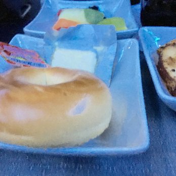 American Airlines - Brunch close-up=bagel with butter and jam and fruit - Airlines Near Me - Chicago, Illinois American Airlines - Brunch close-up=bagel with butter and jam and fruit - Airlines Near Me - Chicago, Illinois