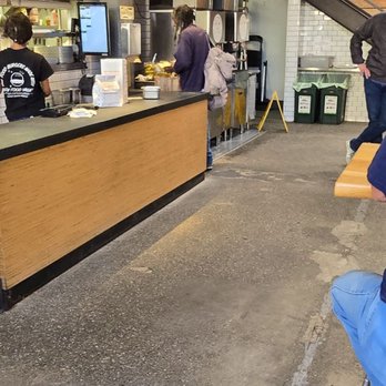 Super Duper Burgers - Vagrant picking through free pickles - Burgers Near Me - Emeryville, California Super Duper Burgers - Vagrant picking through free pickles - Burgers Near Me - Emeryville, California