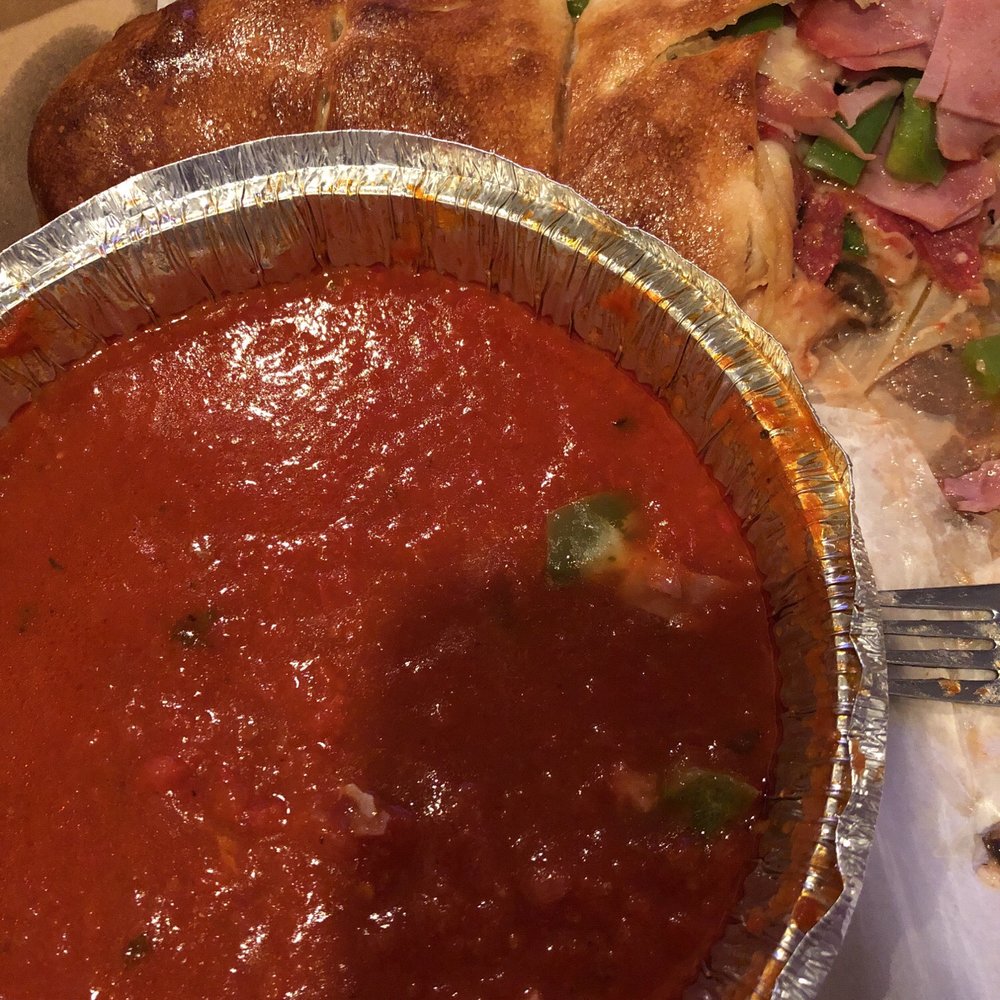 Cafe Villa Pizza - a pizza and a bowl of tomato sauce - Italian Near Me - West Long Branch, New Jersey