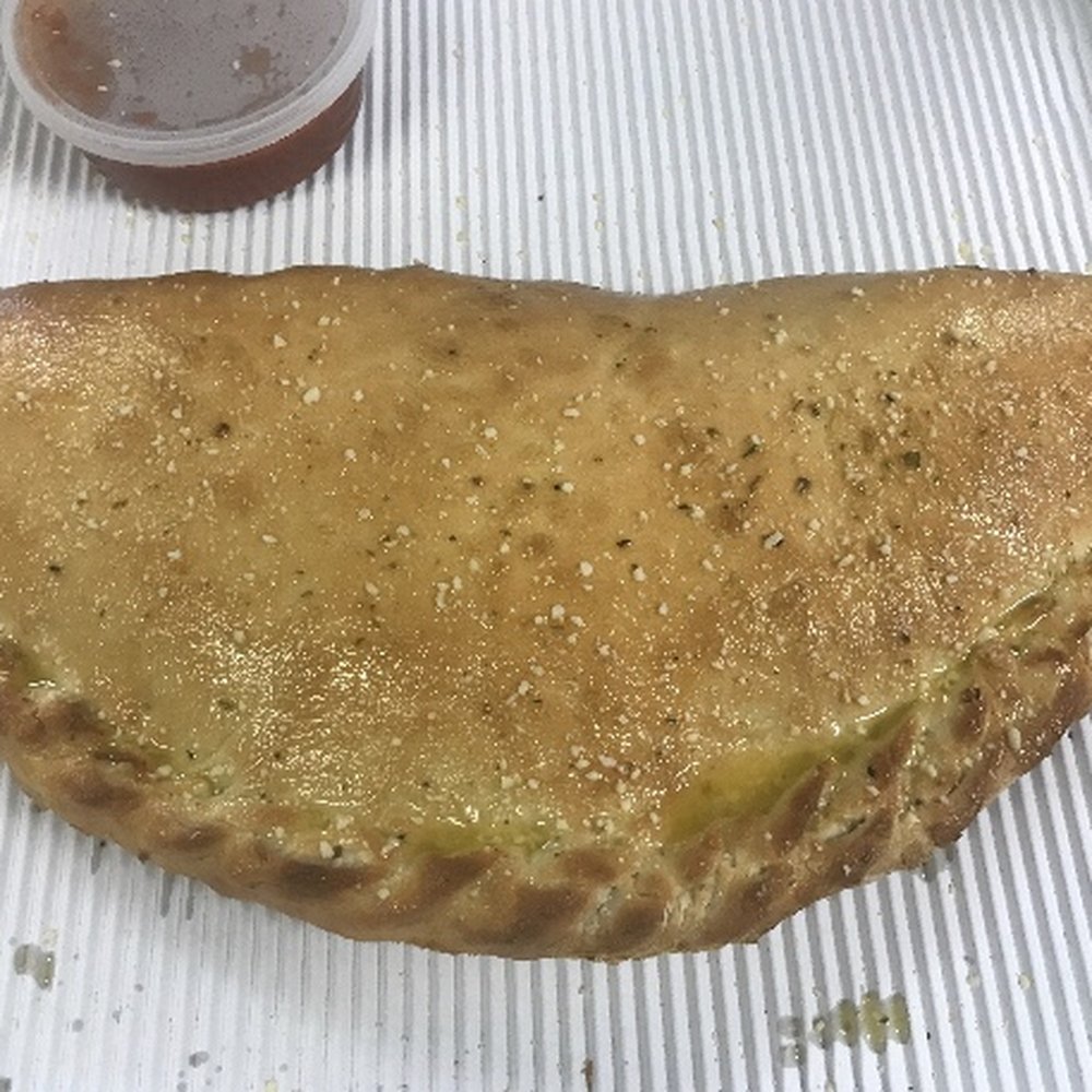 Vesuvio Pizza - a piece of pizza on a tray - Pizza Near Me - Elkhart, Indiana Vesuvio Pizza - a piece of pizza on a tray - Pizza Near Me - Elkhart, Indiana