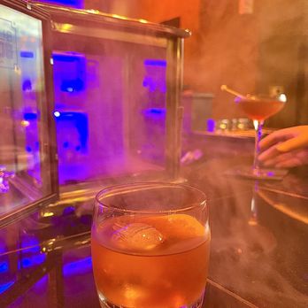 VAULT - Smoked Old Fashioned. Presented in a glass box filled with smoke. Love how the smokiness lingers in this cocktail. - New American Near Me - Hot Springs, Arkansas VAULT - Smoked Old Fashioned. Presented in a glass box filled with smoke. Love how the smokiness lingers in this cocktail. - New American Near Me - Hot Springs, Arkansas