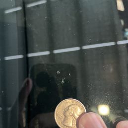 Rock chip next to a quarter for scale