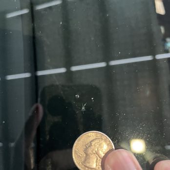 Titan Auto Glass - Rock chip next to a quarter for scale - Auto Glass Services Near Me