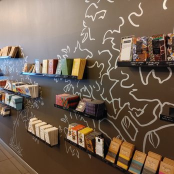 Cocoa + Co - a wall of books on shelves - Desserts Near Me - Chicago, Illinois