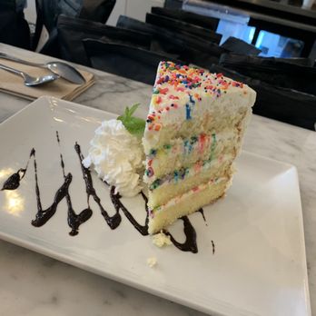 Romancing the Bean Cafe - a slice of the birthday cake ($7.50) -super moist - Coffee & Tea Near Me - Burbank, California Romancing the Bean Cafe - a slice of the birthday cake ($7.50) -super moist - Coffee & Tea Near Me - Burbank, California