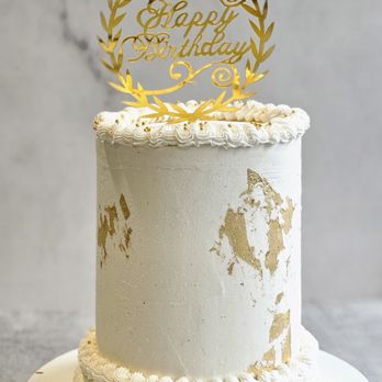 AnviDous Bakery - a white cake with gold decorations - Bakeries Near Me AnviDous Bakery - a white cake with gold decorations - Bakeries Near Me
