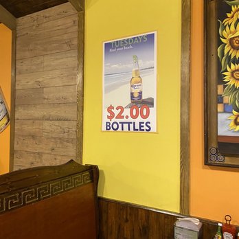 Los Amigos - a bed in a restaurant with a poster on the wall - Mexican Near Me - Kalamazoo, Michigan