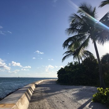 Bill Baggs Cape Florida State Park - A long stretch of rocks boarder a wall and lush tropical plants. Find this at the last parking lot. - Parks Near Me - Key Biscayne, Florida