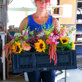 Welch's Farm Market - a woman holding a crate of flowers - Farmers Market Near Me - Wyoming, New York Welch's Farm Market - a woman holding a crate of flowers - Farmers Market Near Me - Wyoming, New York