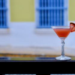 Aqui Se Puede - The "Buenos Dias" cocktail: rum, campari, orange juice, and guava at Aquí Se Puede