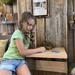 Thistle - young customer listens to a recording about the building's history