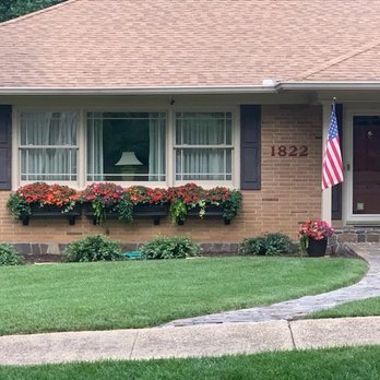 Earthscapes - a brick house with a flag on the front porch - Landscaping Near Me - Chattanooga, Tennessee