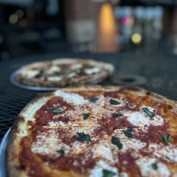 Pastaria 49 - two pizzas on a table - Italian Near Me - Jonesboro, Arkansas Pastaria 49 - two pizzas on a table - Italian Near Me - Jonesboro, Arkansas