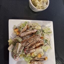 Caesar salad with grilled chicken, side of mashed potatoes Caesar salad with grilled chicken, side of mashed potatoes