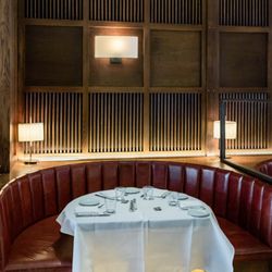 Lulu Kitchen & Bar - Interior of Lulu Kitchen & Bar featuring signature banquette with burgundy leather booth, white tablecloth, fully set table, ...