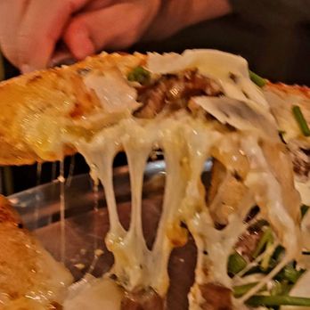 Mellow Mushroom - Cheesy action shot of the magic happening. - Pizza Near Me - Winston-Salem, North Carolina