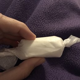 a hand holding a wrapper a hand holding a wrapper