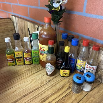 Los Politos - 14 bottles of salsa on every table. - Mexican Near Me - Phoenix, Arizona