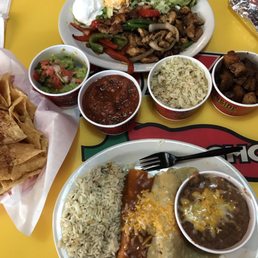 Chicken fajitas, enchiladas, salsa and chips with guacamole.
