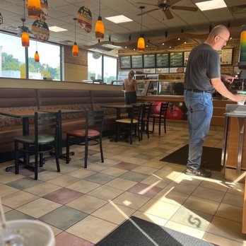Subway - a man standing at a counter in a fast food restaurant - Sandwiches Near Me - Farmer City, Illinois