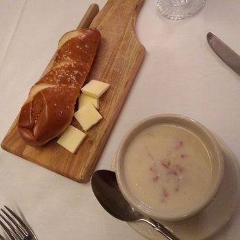 Mader's - A warm pretzel roll with butter and cup of Reuben soup - German Near Me - Milwaukee, Wisconsin