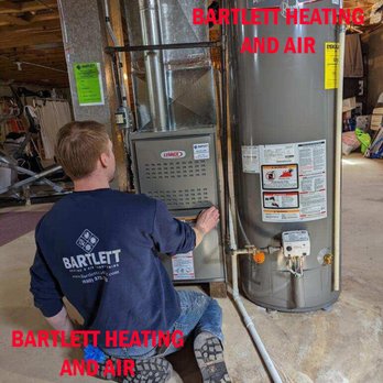 Bartlett Heating & Air Conditioning - Technician Big Sam with a new Lennox furnace - Heating & Air Conditioning/HVAC Near Me - Bartlett, Illinois