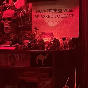 Burgundy Room - a sign on a shelf in a bar - Dive Bars Near Me - Los Angeles, California