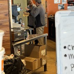 Barry Bagels - Lambertville - People preparing food and drinks and then standing and eating behind the counter