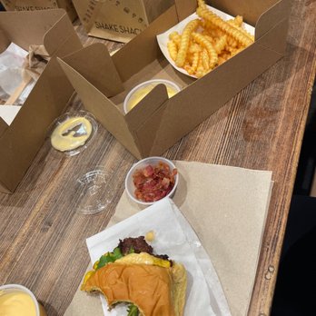 Shake Shack - a burger and fries on a table - Fast Food Near Me - Dallas, Texas Shake Shack - a burger and fries on a table - Fast Food Near Me - Dallas, Texas