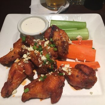 Stanford's - Hot wings topped with blue cheese and a side of celery and carrots. - American Near Me - Seattle, Washington Stanford's - Hot wings topped with blue cheese and a side of celery and carrots. - American Near Me - Seattle, Washington