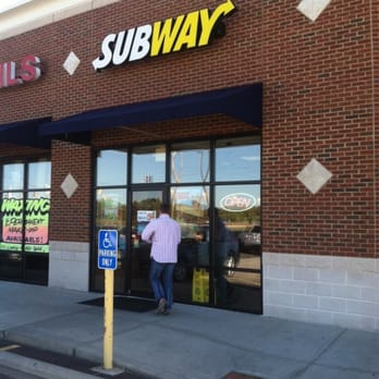 Subway - a woman entering a subway restaurant - Fast Food Near Me - Harrison, Ohio