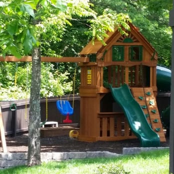 KC Pro Assembly - a wooden play structure in a backyard - General Contractors Near Me - Independence, Missouri KC Pro Assembly - a wooden play structure in a backyard - General Contractors Near Me - Independence, Missouri