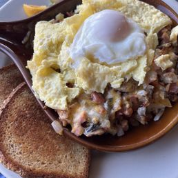 Yall skillet with two scrambled and one poached egg Yall skillet with two scrambled and one poached egg