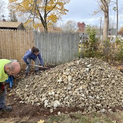 All Set Landscaping and Plowing - Owner Chris and Heather putting rock down