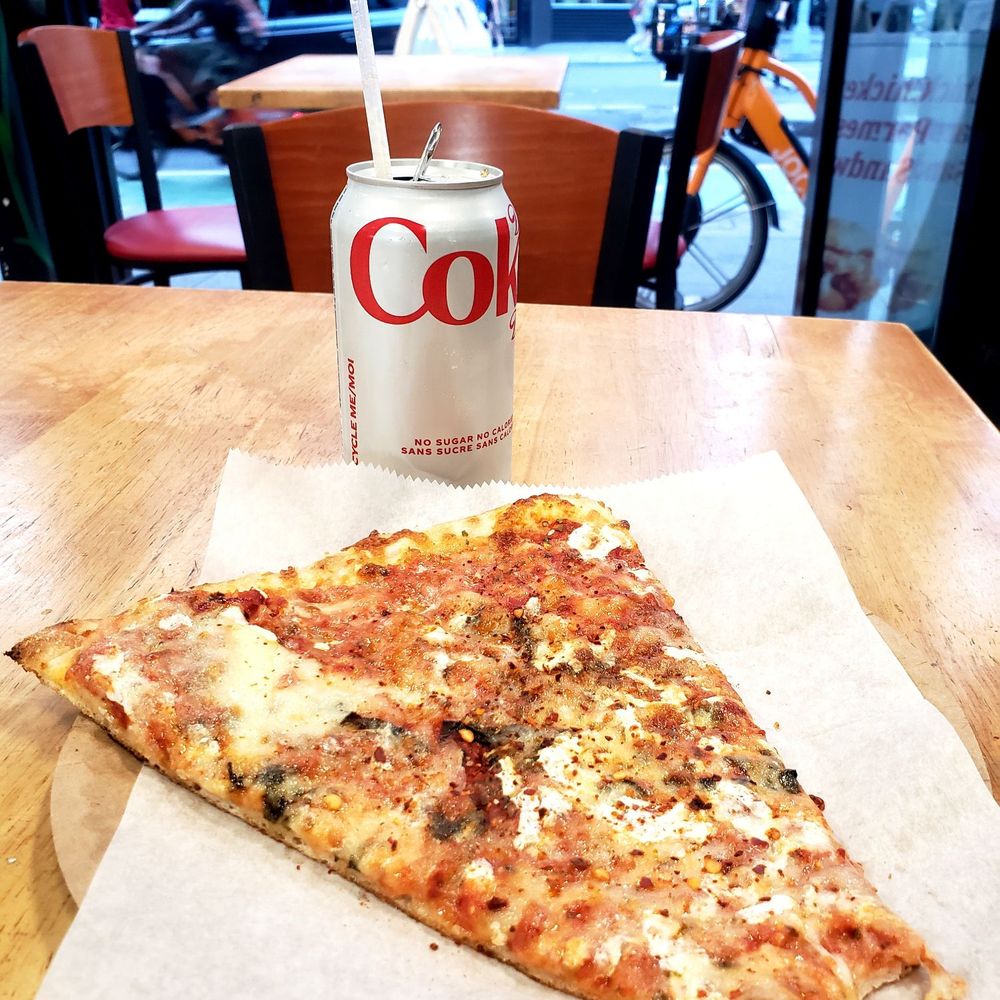 a slice of pizza and a drink a slice of pizza and a drink