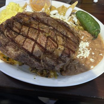 Rodeo Cafe - Chilaquiles verde with rib eye steak scrambled eggs and refried beans - Breakfast & Brunch Near Me - Riverside, California Rodeo Cafe - Chilaquiles verde with rib eye steak scrambled eggs and refried beans - Breakfast & Brunch Near Me - Riverside, California
