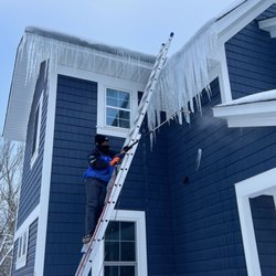 Ice Dam Guys - Removing an ice dam from a ladder in Minneapolis in January 2023.