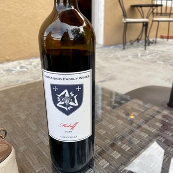 Passion Cellars - a bottle of wine on a table - Wineries Near Me - Jerome, Arizona Passion Cellars - a bottle of wine on a table - Wineries Near Me - Jerome, Arizona