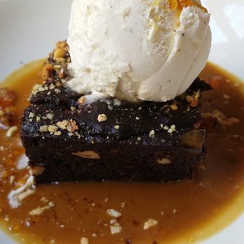 Mildreds - Vegan hazelnut brownie with salted caramel sauce and ice cream. - Vegan Near Me - London, XGL Mildreds - Vegan hazelnut brownie with salted caramel sauce and ice cream. - Vegan Near Me - London, XGL