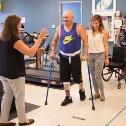 Precision Rehabilitation - Therapist, Christy, assisting a patient to walk.