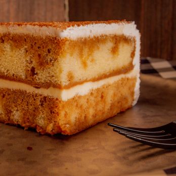 Ultimate Cheesecake - a slice of cheesecake on a plate with a fork - Bakeries Near Me - Corpus Christi, Texas Ultimate Cheesecake - a slice of cheesecake on a plate with a fork - Bakeries Near Me - Corpus Christi, Texas