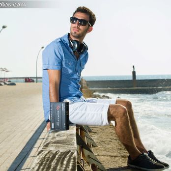 DJ Aviel Altit - a man sitting on a bench near the ocean - DJs Near Me DJ Aviel Altit - a man sitting on a bench near the ocean - DJs Near Me