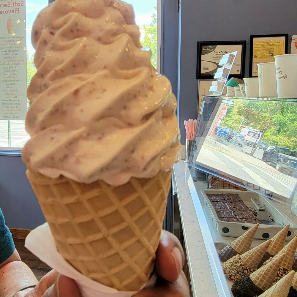 Bmore Licks - Butterfinger soft serve ice cream in a waffle cone. - Ice Cream & Frozen Yogurt Near Me - Baltimore, Maryland Bmore Licks - Butterfinger soft serve ice cream in a waffle cone. - Ice Cream & Frozen Yogurt Near Me - Baltimore, Maryland