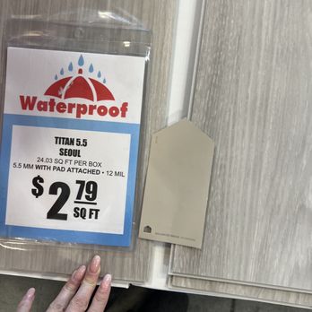 Carpet Liquidators - a person standing next to a waterproof sign - Carpeting Near Me - Tacoma, Washington