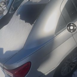 The car covered in snow after Bil lied and said it was pushed from across the street