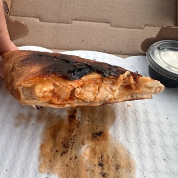 Famous Pizza - Buff chic calzone half eaten lol - Pizza Near Me - Johnston, Rhode Island