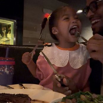 Morton's The Steakhouse - The 16 oz. Prime Cajun Ribeye Steak she's enjoying :) - Steakhouses Near Me - Reston, Virginia