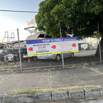 Top's Deli - a sign on a chain link fence - Delis Near Me - Honolulu, Hawaii
