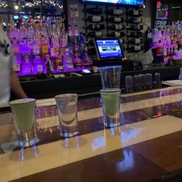 a row of shot glasses on a bar a row of shot glasses on a bar