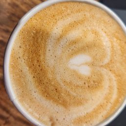 a cup of coffee on a wooden table a cup of coffee on a wooden table